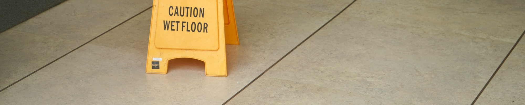 Clean Commercial Tile Floor with Caution Sign