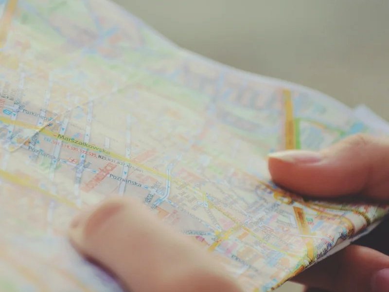 Holding a colorful paper map